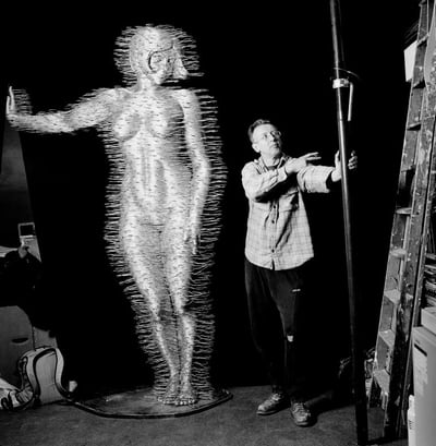 Sculptor David Mach with one of his sculptures, photographed by Eamonn McCabe