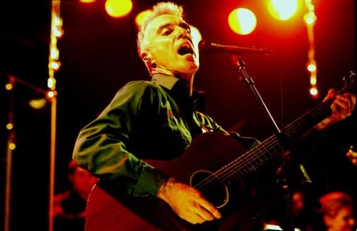 Musician David Byrne performing live, photographed by Eamonn McCabe