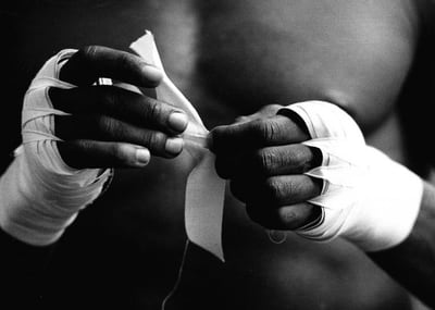 Boxer Sylvester Mittee taping his hands, photographed by Eamonn McCabe
